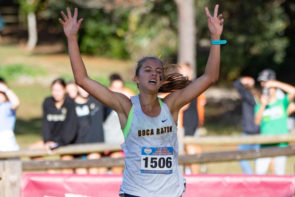 Boca Raton's Emma O'Day celebrates her first place finish in the Class 4A cross country state championships at Apalachee Regional Park on Saturday, Nov. 5, 2022.