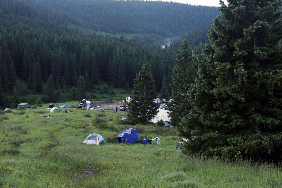 The entrance to the annual Rainbow Gathering as seen on Friday, July 2, 2021, in the Carson National Forest, outside of Taos, N.M. More than 2,000 people have made the trek into the mountains of northern New Mexico as part of an annual counterculture gathering of the so-called Rainbow Family. While past congregations on national forest lands elsewhere have drawn as many as 20,000 people, this year’s festival appears to be more reserved. Members(AP Photo/Cedar Attanasio)