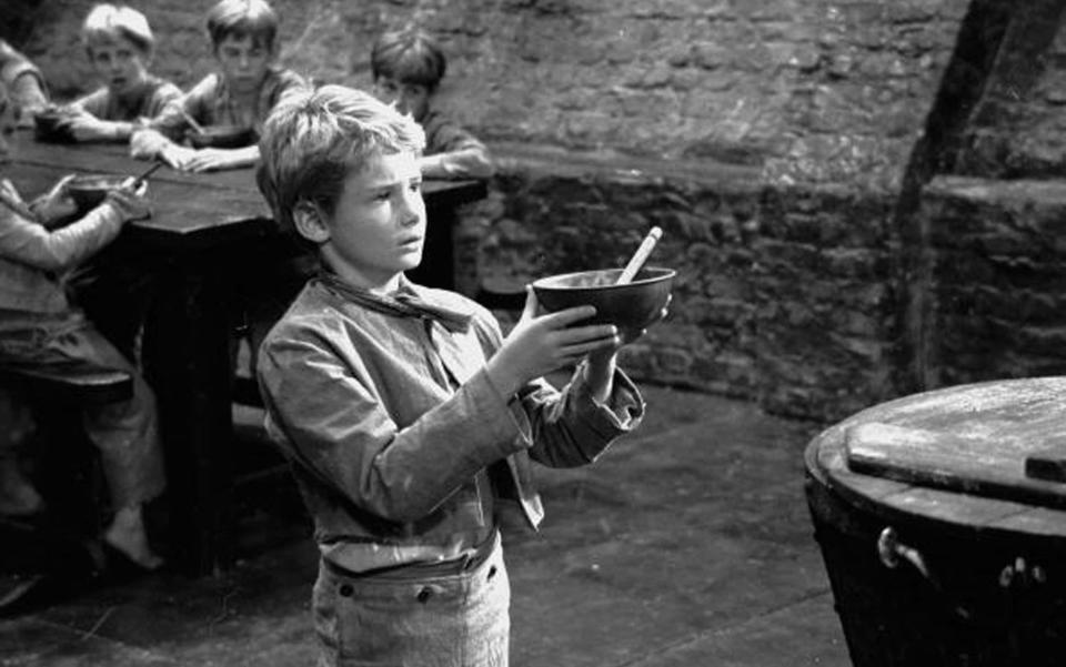 Mark Lester as Oliver Twist says, 'Please, sir. I want some more' in the 1968 musical - Chris Ware/Getty Images