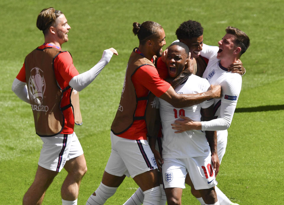 England's Raheem Sterling is congratulated by teammates after scoring his team's first goal during the Euro 2020 soccer championship group D match between England and Croatia at Wembley stadium in London, Sunday, June 13, 2021. (AP Photo/Justin Tallis, Pool)