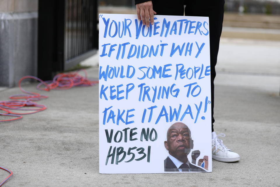 A person holds a placard outside the Georgia state Capitol in Atlanta to protest HB 531, March 1, 2021. (Photo: Dustin Chambers/Reuters)