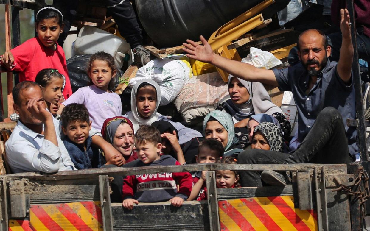 Palestinians flee as Israel Defense Forces tanks seize the Palestinian side of the Rafah crossing