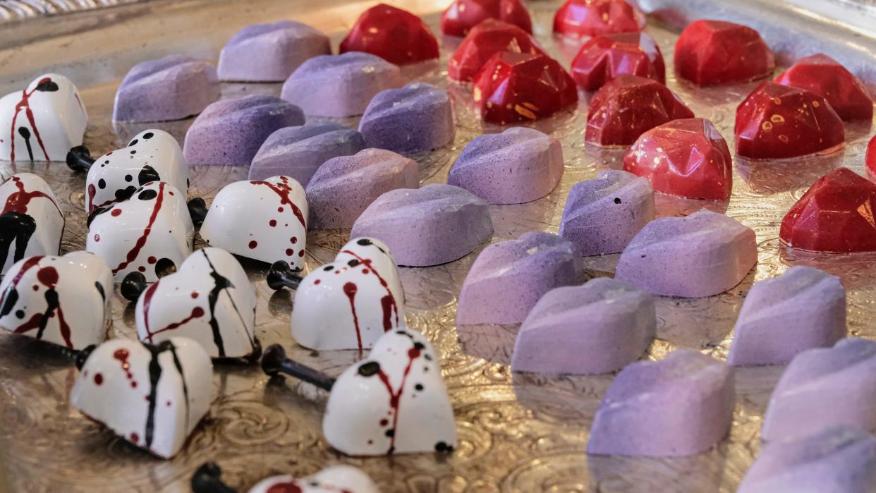 Adam Turoni's inventive flavor combinations for Valentine's Day also are paired with surprising and delightful textures, such as the burst of Pop Rocks in the 'Screw Love' Truffle or the crispness of freeze-dried berries in the Berry Kiss lips. In the background is the Passion Fruit Heart Truffle.