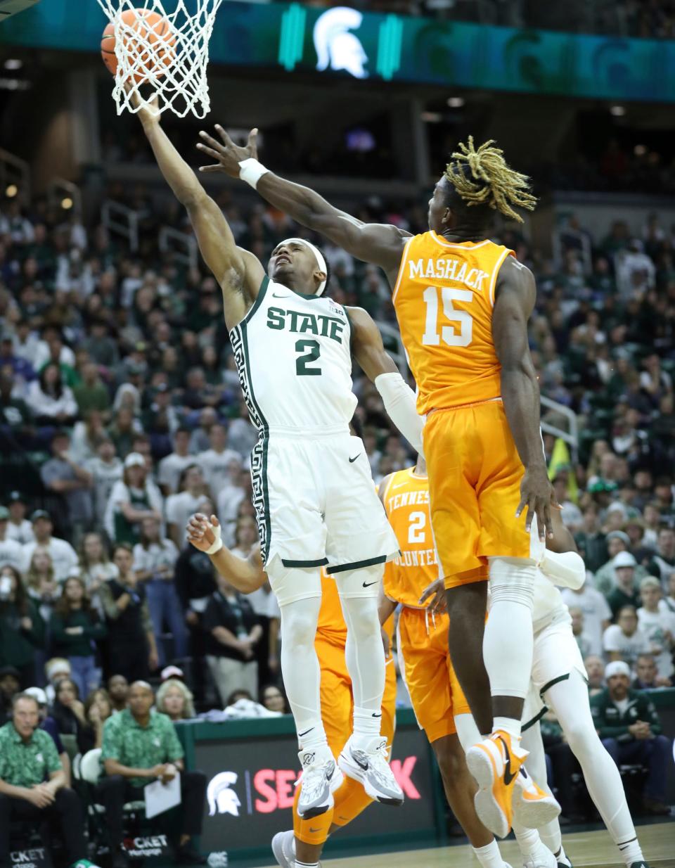 Michigan State Spartans guard Tyson Walker (2) scores against Tennessee Volunteers guard Jahmai Mashack (15) during second-half action at Breslin Center in East Lansing on Sunday, Oct. 29, 2023.