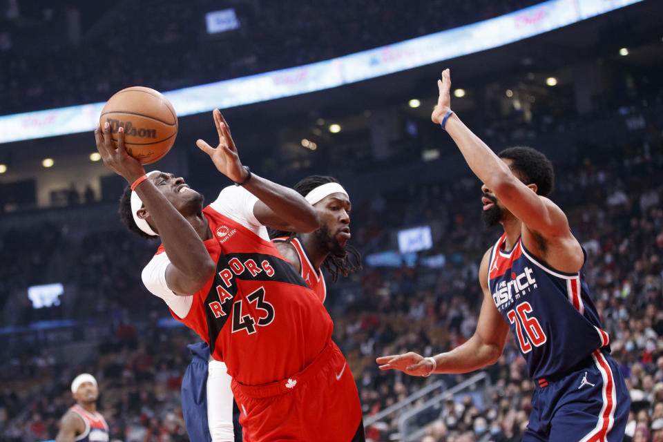 Toronto Raptors forward Pascal Siakam (43) shoots over Washington Wizards guard Spencer Dinwiddie (26) during first-half NBA basketball game action in Toronto, Sunday, Dec. 5, 2021. (Cole Burston/The Canadian Press via AP)