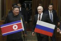 Russian President Vladimir Putin, right, and North Korea's leader Kim Jong Un smile during their meeting at the Pyongyang Sunan International Airport outside Pyongyang, North Korea, on Tuesday, June 18, 2024. (Gavriil Grigorov, Sputnik, Kremlin Pool Photo via AP)