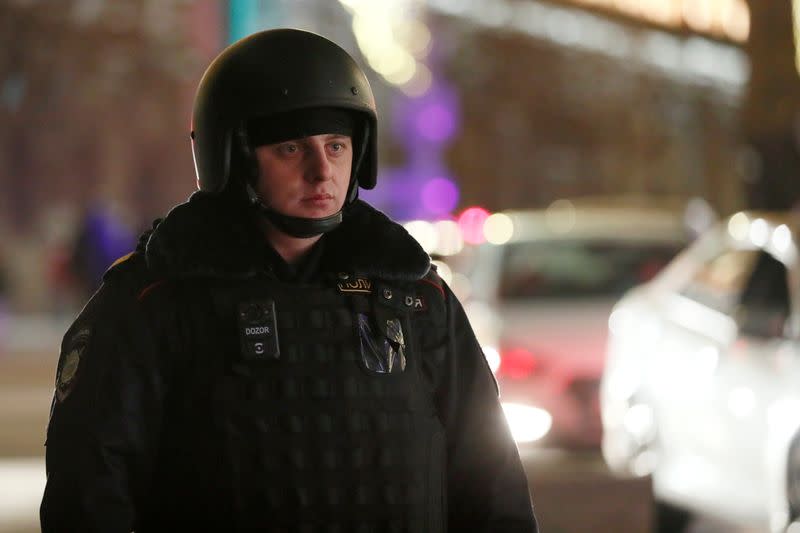 A security officer blocks a street near the Federal Security Service (FSB) building after a shooting incident, in Moscow