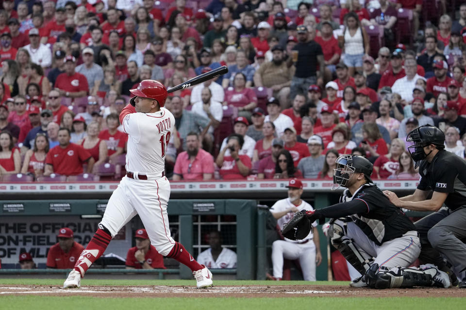 Cincinnati Reds' Joey Votto follows through on a grounder during the first inning of a baseball game against the Miami Marlins on Friday, Aug. 20, 2021, in Cincinnati. Votto reached first on an error. (AP Photo/Jeff Dean)