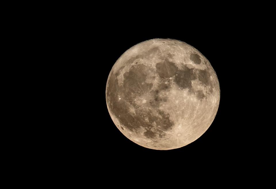 A full moon shines in the night sky in Surprise, Arizona on Aug. 1, 2023.