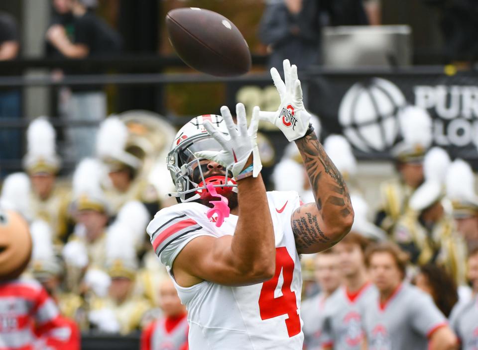 Ohio State wide receiver Julian Fleming catches a pass during warmups prior to the game against Purdue.