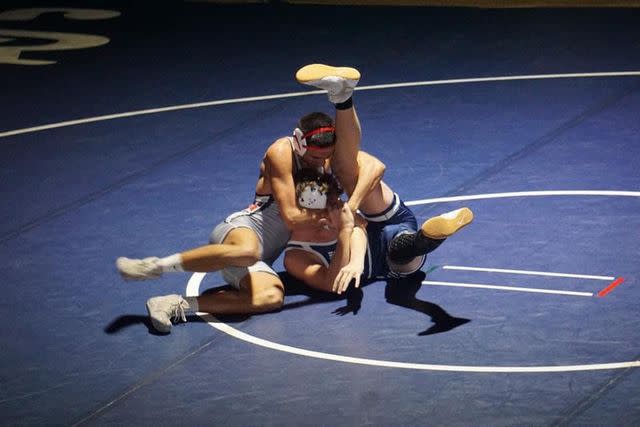<p>Courtesy of Madison Rawlings </p> Noah Presgrove (in the gray) during a high school wrestling match.