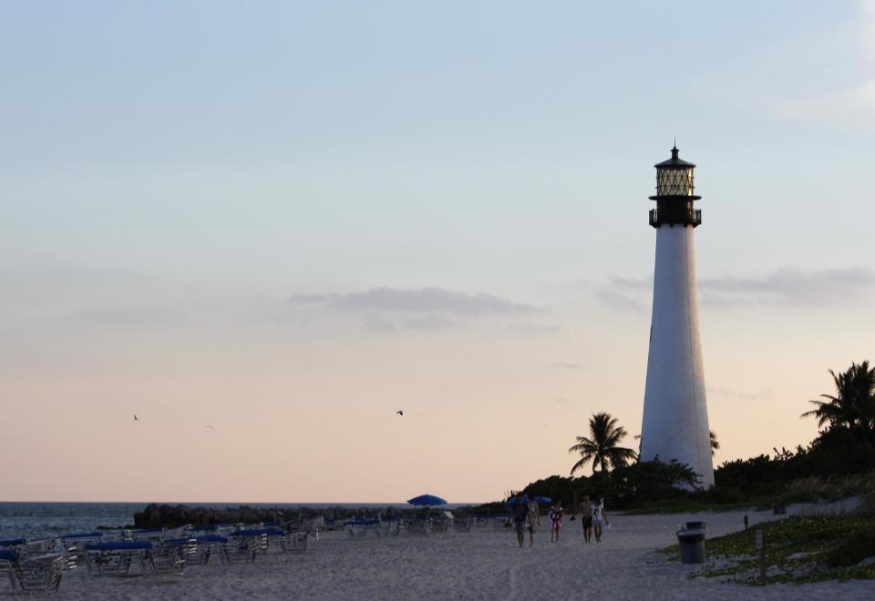 FILE - This Aug. 20, 2012 file photo shows the Cape Florida lighthouse at sunset at Bill Baggs Cape Florida State Park, in Key Biscayne, Fla. Cape Florida State Park is number seven on the 2013 list of Top 10 Beaches produced annually by coastal expert Stephen P. Leatherman, also known as "Dr. Beach," director of Florida International University's Laboratory for Coastal Research. (AP Photo/Lynne Sladky, file)