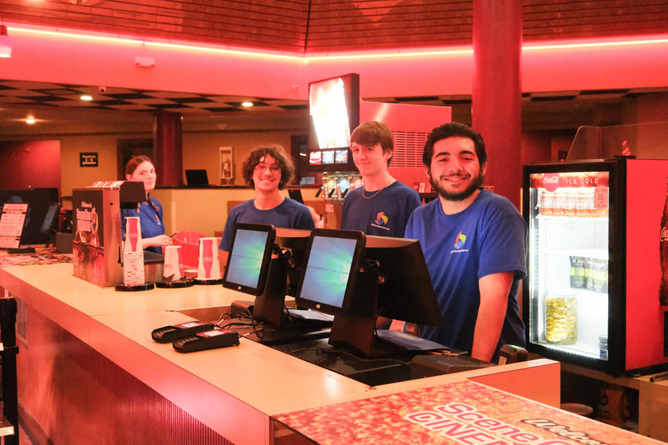 Employees of the newly opened Scene One Westgate Mall Cinemas await customers Wednesday at the grand opening of Amarillo's newest theater.