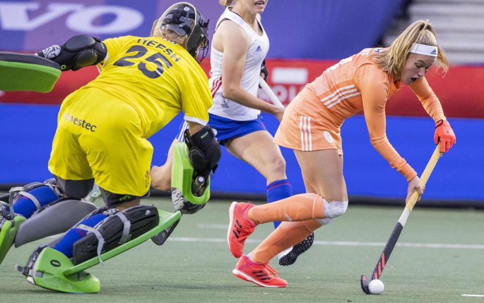 Pien Dicke (R) of the Netherlands passes goalkeeper Sabbie Heesh (L) and Elizabeth Neal (C) of Great Britain during their women's field hockey international match in Amstelveen, on October 27, 2020.  - AFP