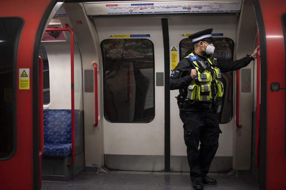 A British Transport Police officer wears a face mask on the London Underground Central line during what would normally be the evening rush hour, as the UK continues in lockdown to help curb the spread of the coronavirus.