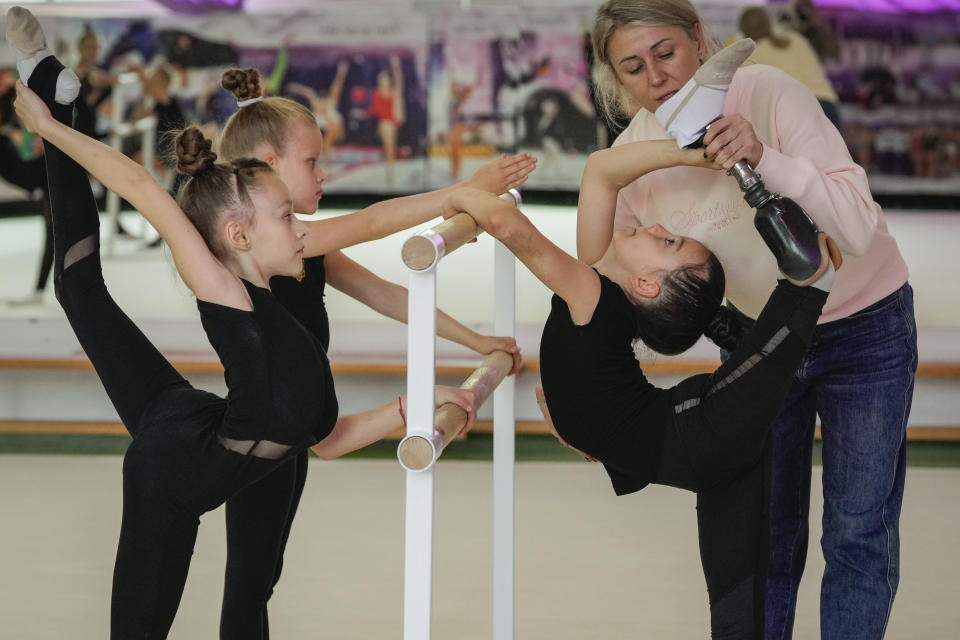 Oleksandra Paskal, an 8-year-old girl with a prosthetic leg, practices rhythmic gymnastics with other girls with coach Inga Kovalchuk in Chornomorsk, Odesa region, Ukraine, Thursday, May 16, 2024. “My primary task today is not to achieve high results in sports but to preserve the mental and physical health of our children,” Kovalchuk says. (AP Photo/Efrem Lukatsky)