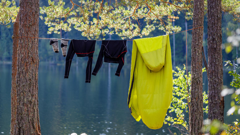 reasons you need a sleeping bag liner: camping gear hanging up