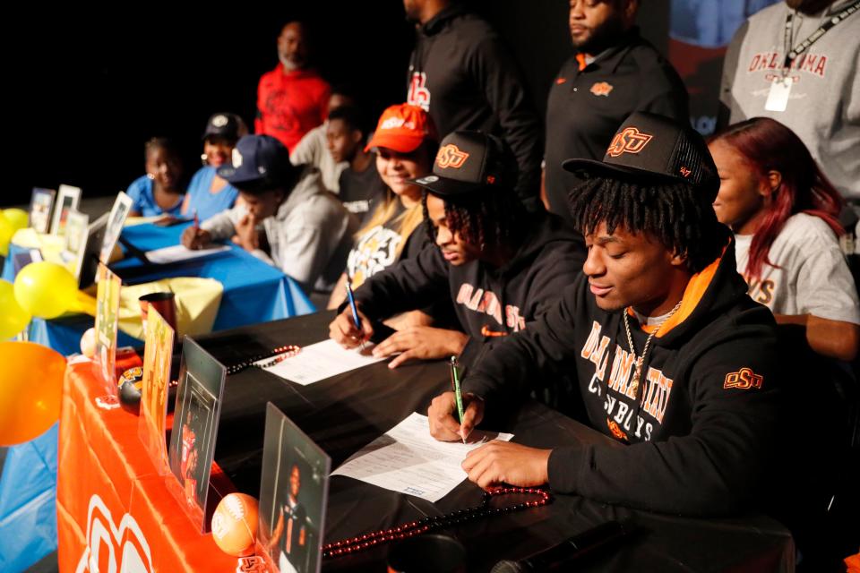 Del City stars Rodney Fields, right, and LaDainian Fields sign with Oklahoma State during a ceremony in Del City on Jan. 19.