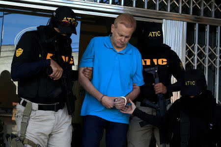 Agents of the Technical Criminal Investigation Agency (ATIC) escort Kentucky attorney Eric Christopher Conn, 57, wanted by the FBI over his role in a disability fraud scheme, in Tegucigalpa, Honduras December 5, 2017. REUTERS/Jorge Cabrera