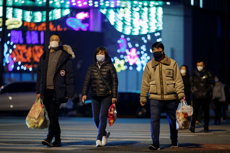 People wear face masks outside a shopping mall in Beijing as the country is hit by an outbreak of the novel coronavirus
