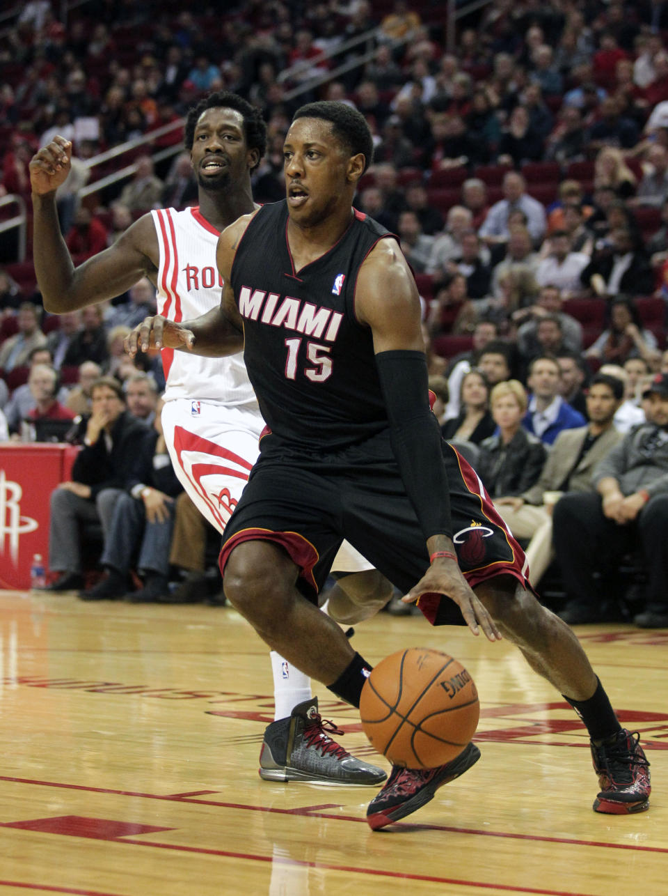 Miami Heat guard Mario Chalmers (15) drives past Houston Rockets guard Pat Beverley during the first quarter of an NBA basketball game, Tuesday, March, 4, 2014, in Houston. (AP Photo/Patric Schneider)