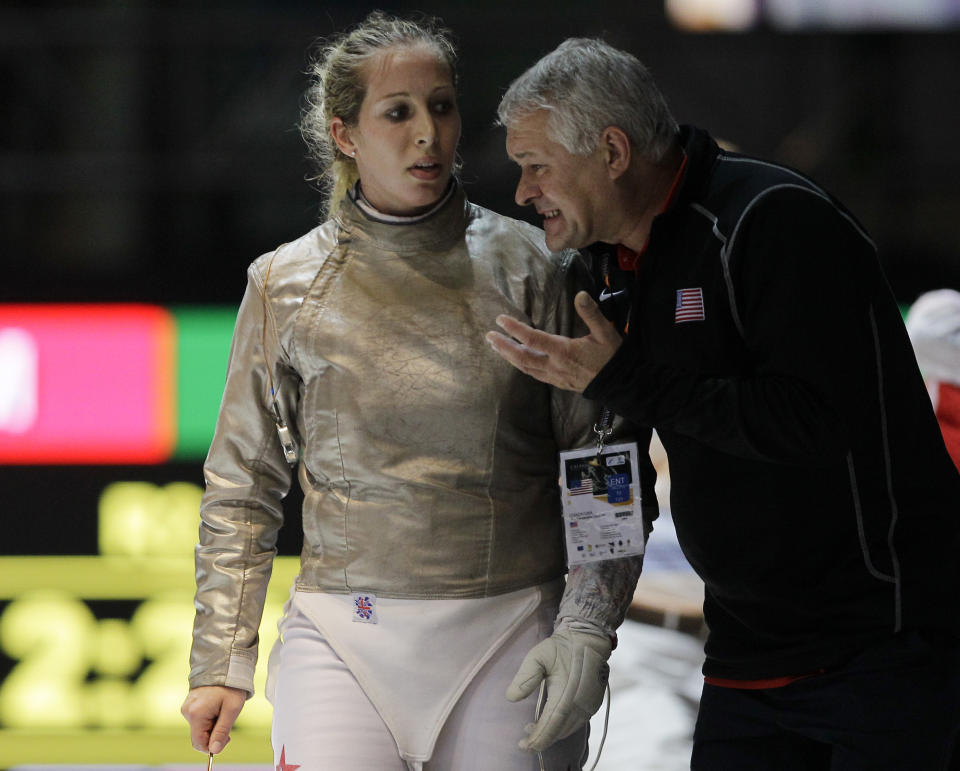 Mariel Zagunis, of the United States, talks with her coach after losing a women's individual sabre final match against Russia's Sophia Velikaia at the World Fencing Championship in Catania, Italy, Wednesday, Oct. 12, 2011. (AP Photo/Antonio Calanni)