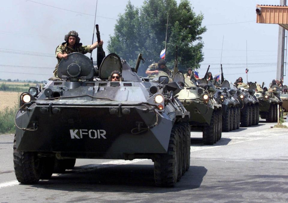 FILE - Russian soldiers drive their military armored vehicles through the Serbian village of Simanovci , 9 miles ( 15 kms ) west of the Serbian capital Belgrade, on June 11, 1999. Well before Russian tanks and troops rolled into Ukraine, Vladimir Putin was using the bloody breakup of Yugoslavia in the 1990s to ostensibly offer justification for the invasion of a sovereign European country. The Russian president has been particularly focused on NATO’s bombardment of Serbia in 1999 and the West’s acceptance of Kosovo’s declaration of independence in 2008. He claims both created an illegal precedent that shattered international law and order, apparently giving him an excuse to invade Ukraine. (AP Photo/Darko Vojinovic, File)