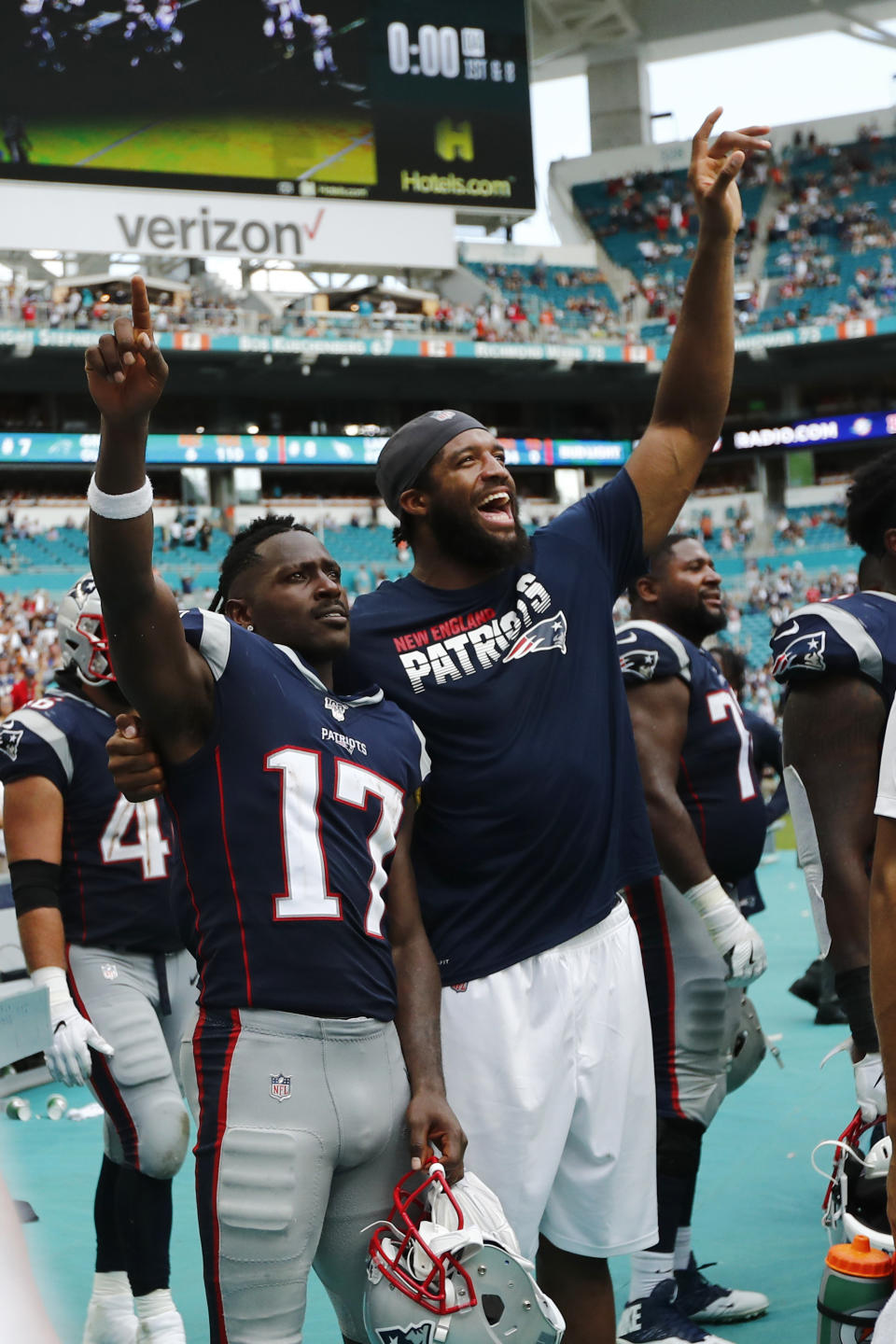 New England Patriots wide receiver Antonio Brown (17) and defensive end Deatrich Wise, celebrate during the end of the second half at an NFL football game, Sunday, Sept. 15, 2019, in Miami Gardens, Fla. The Patriots defeated the Dolphins 43-0. (AP Photo/Brynn Anderson)