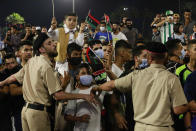 Hundreds of demonstrators protest in Tripoli, Libya, on Friday, Sept. 24, 2021, in opposition to the country’s parliament passing a vote of no-confidence in the transitional government. The motion, passed on Tuesday, represents a challenge to planned December elections and impedes efforts to unite the oil-rich North African nation after a decade of turmoil. (AP Photo/Yousef Murad)