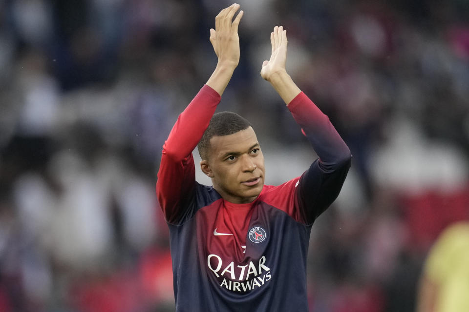 PSG's Kylian Mbappe greets supporters before the French League One soccer match between Paris Saint-Germain and Toulouse at the Parc des Princes stadium in Paris, Sunday, May 12, 2024. (AP Photo/Christophe Ena)