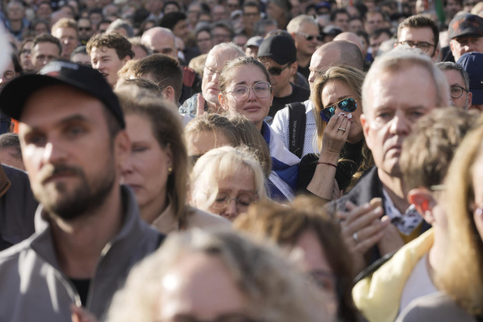 Two women react emotionally during a speech at a demonstration against antisemitism and to show solidarity with Israel in Berlin, Germany, Sunday, Oct. 22, 2023. (AP Photo/Markus Schreiber)