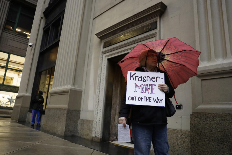 A protestor holds a sign in support of Mumia Abu-Jamal outside the offices of District Attorney Larry Krasner, Friday, Dec. 28, 2018, in Philadelphia. A judge issued a split ruling Thursday that grants Abu-Jamal another chance to appeal his 1981 conviction in a Philadelphia police officer's death. (AP Photo/Matt Slocum)