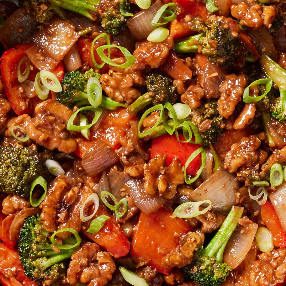 walnut broccoli stirfry on white rice with red bell peppers and glazy sauce