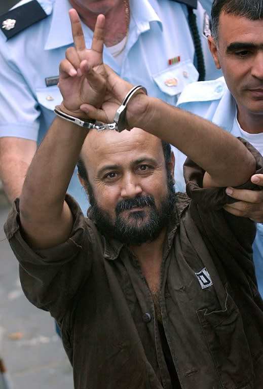 Hunger strike leader Marwan Barghouti is an iconic figure for many Palestinians. Here he is seen with his cuffed hands raised above his head flashing a peace sign during his trial in 2003, an image that has been daubed on walls across the West Bank