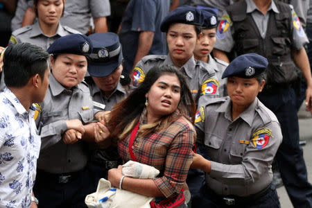 Myanmar police officers detain a student who takes part in a rally demanding peace at the war-torn Kachin State, in Yangon, Myanmar May 12, 2018. REUTERS/Stringer