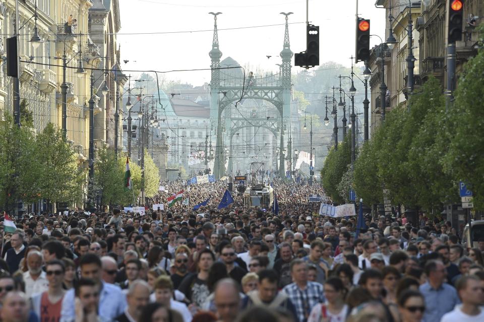 FILE - In this April 2, 2017 file photo participants walk during the rally, organized by the Freedom for Education movement, in downtown Budapest, Hungary. Lawmakers from Hungarian Prime Minister Viktor Orban’s Fidesz party are expected to approve a draft education bill that critics say targets a university founded by billionaire philanthropist George Soros. The bill, scheduled to be voted on Tuesday, April 4, 2017, modifies rules regulating foreign universities in Hungary. Central European University says parts of the bill directly target it, and could force it to close. (Zoltan Balogh/MTI via AP,file)