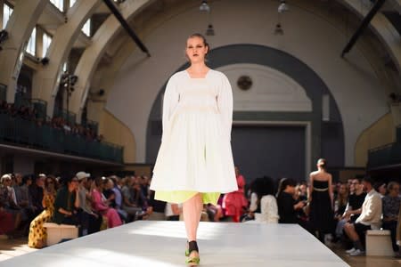 Models present creations during the Molly Goddard catwalk show during London Fashion Week in London