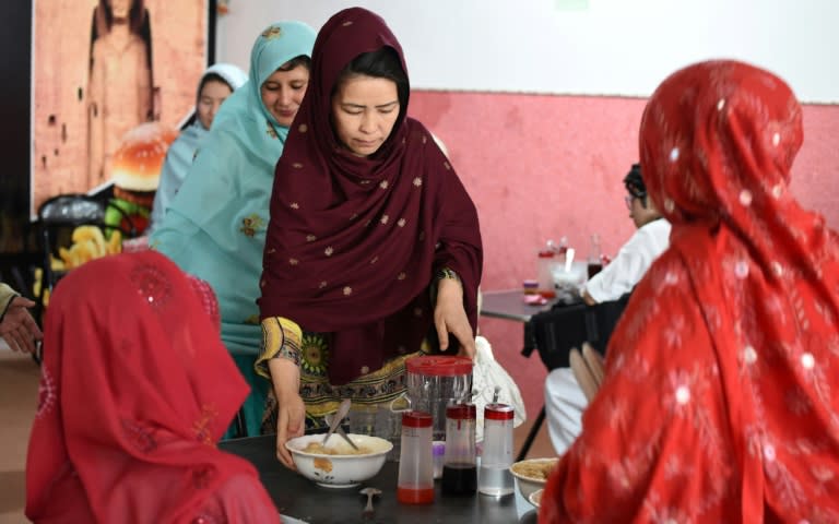 Hameeda Ali Hazara (C), who is from Pakistan's Shiite ethnic minority Hazara community, runs the "Hazara" restaurant -- a project that aims to help to help families and female victims of sectarian attacks