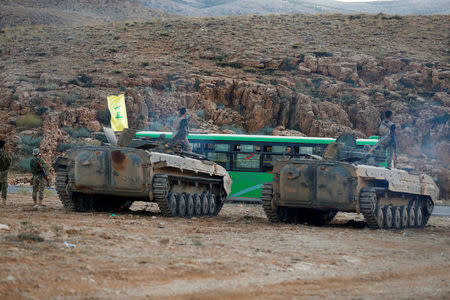 Hezbollah fighters are seen escorting buses in Jroud Arsal, Lebanon August 2, 2017. REUTERS/ Mohamed Azakir