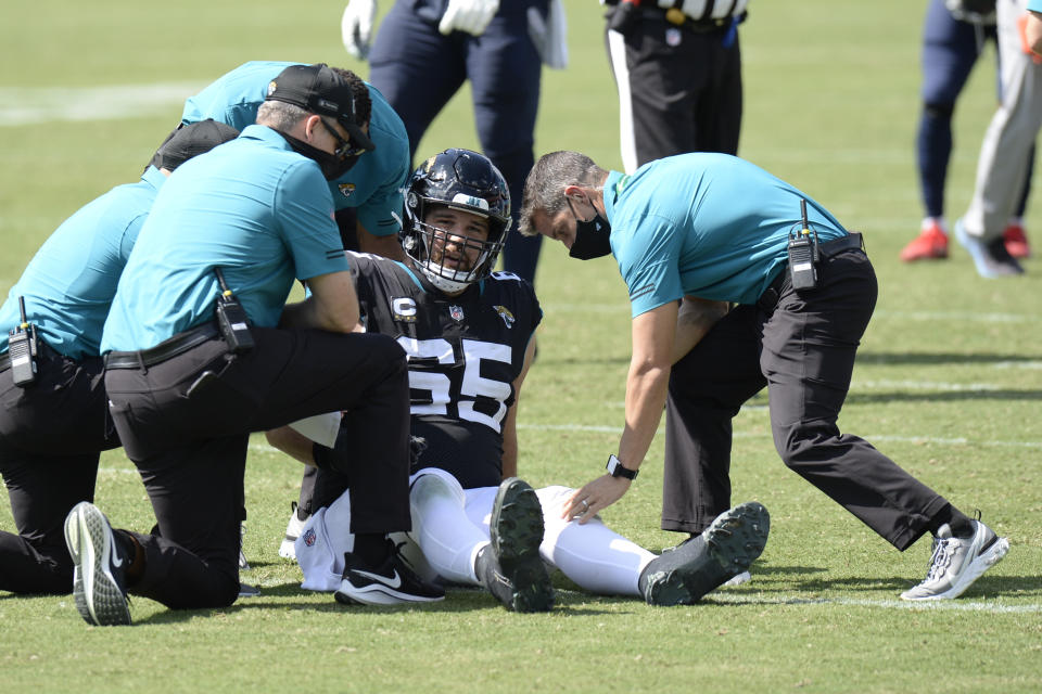 Jacksonville Jaguars center Brandon Linder (65) is helped by medial personnel after being injured in the second half of an NFL football game against the Tennessee Titans Sunday, Sept. 20, 2020, in Nashville, Tenn. (AP Photo/Mark Zaleski)