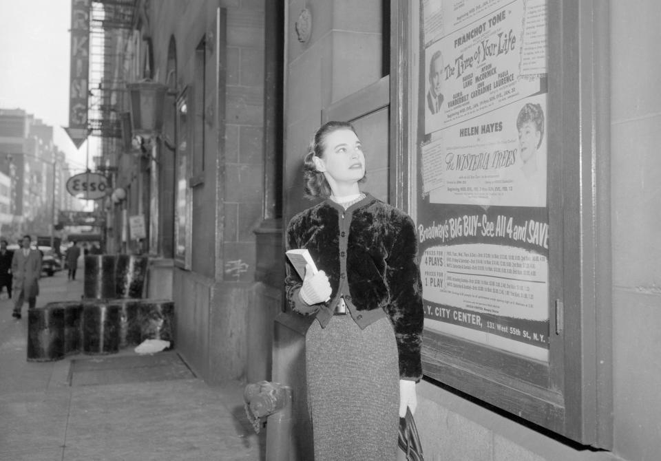 (Original Caption) Gloria Vanderbilt Stokowska, scans a billboard at City Center bearing her name, as she began rehearsals today for her role in William Saroyan's The Time of Your Life, which opens at the 55th Street Playhouse on January 19th. Miss Vanderbilt recently announced her separation from maestro Leopold Stokowski and said she plans to divorce him. They have been married nine years and have two children.