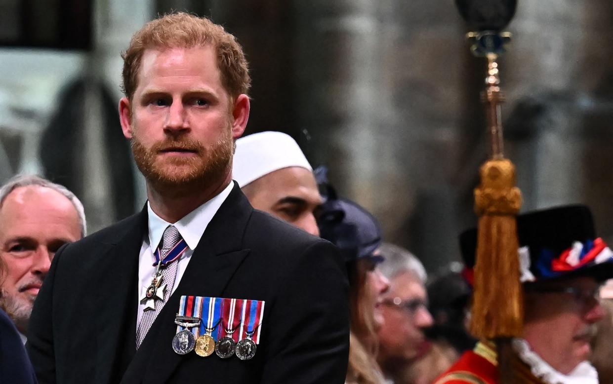 Prince Harry watched King Charles III leave Westminster Abbey - AFP