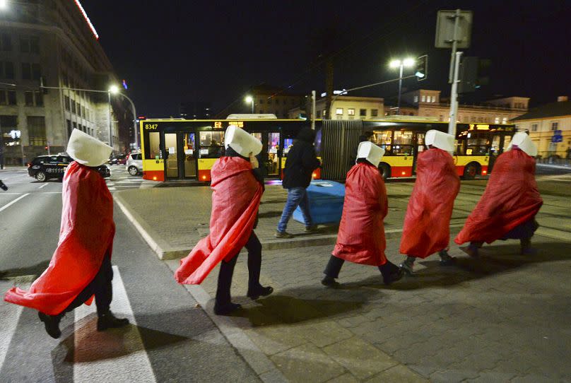 Polish women dressed as characters inspired by Margaret Atwood's novel "The Handmaid's Tale," take part in a protest against an abortion ruling in Warsaw, December 2020