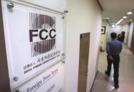 A man passes by the Seoul Foreign Correspondent's Club office in Seoul, South Korea, Tuesday, March 19, 2019. International journalists' organizations have expressed concern over South Korea's press freedoms after the country's ruling party singled out a Bloomberg reporter over what it claimed was a "borderline treacherous" article insulting President Moon Jae-in, resulting in threats to the reporter's safety. (AP Photo/Ahn Young-joon)