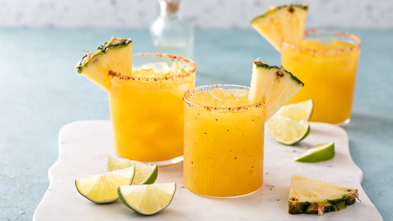 Pineapple cocktails in Tajín-rimmed glasses