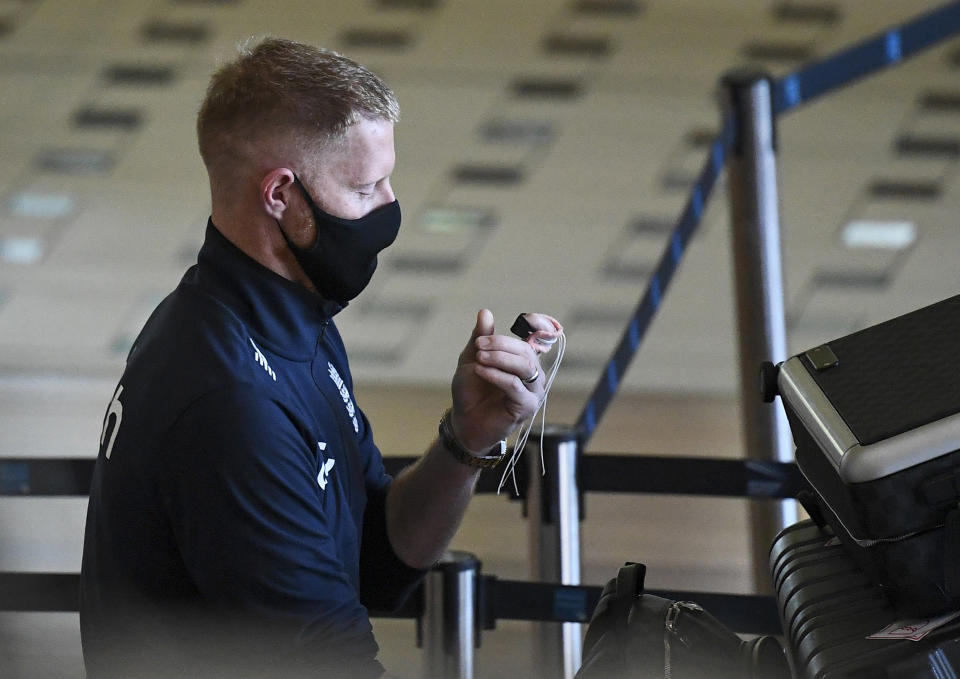 England cricketer Ben Stokes walks through the terminal at Brisbane Airport in Australia, Saturday, Nov. 6, 2021. The England cricket team have arrived in Australia ahead of a five test Ashes series beginning on Dec. 8 in Brisbane. (Dave Hunt/AAP Image via AP)