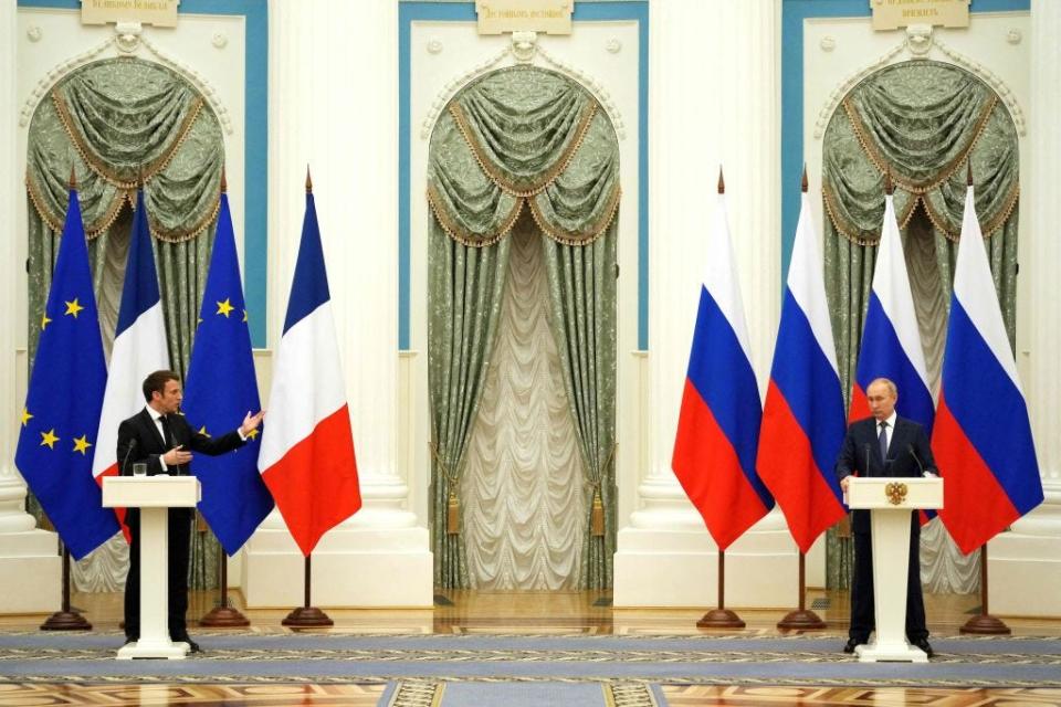 Russian President Vladimir Putin (R) listens during a joint press conference with French President Emmanuel Macron in Moscow, on February 7, 2022