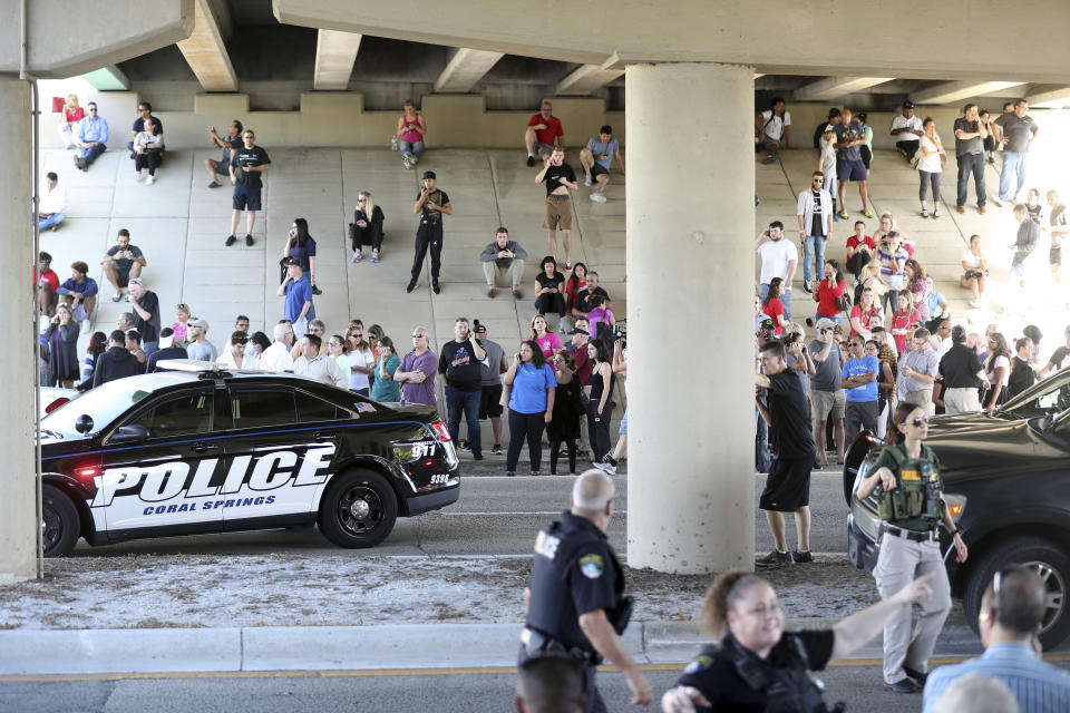 Parents and family gather near Marjory Stoneman Douglas High School after Wednesday’s shooting. (AP)