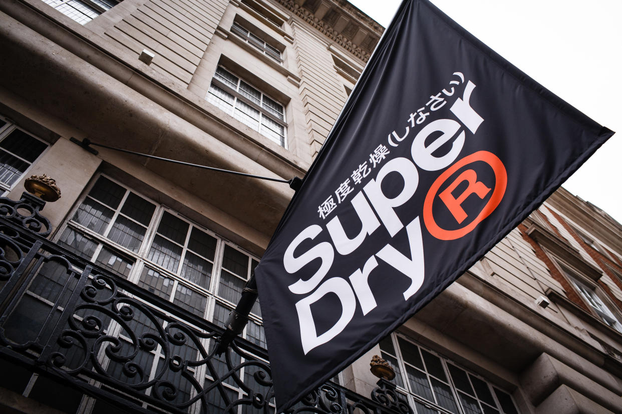 A flag for clothing retailer Superdry hangs outside the company's flagship branch on Regent Street in London, England, on July 7, 2019. Superdry will release its full-year results this Thursday, July 10, a week later than planned, after announcing their postponement in late June. Recent months have seen Superdry beset with problems, from poor sales performance to a boardroom walkout after founder Julian Dunkerton won a shareholder vote to rejoin the company, becoming interim CEO in April. The following month saw the chain issue its third profit warning in a year, adding to investor woes. (Photo by David Cliff/NurPhoto via Getty Images)