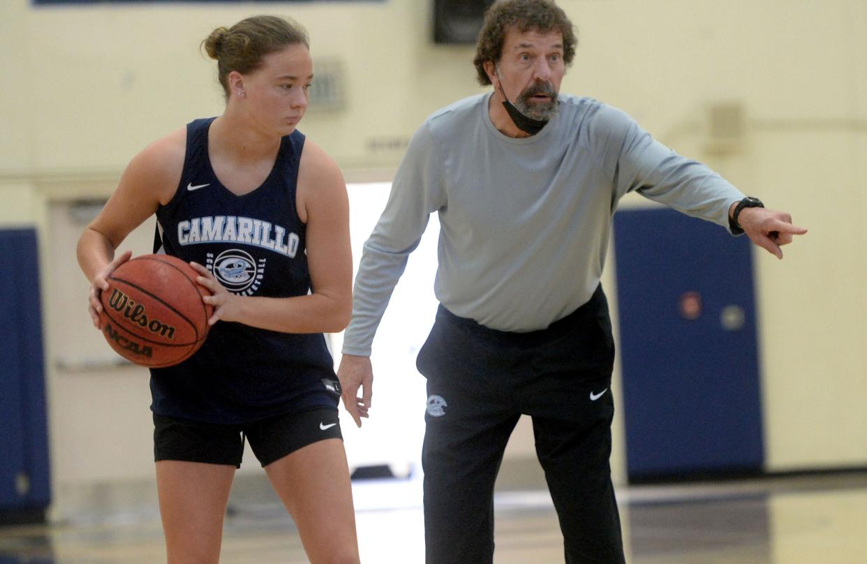 Head coach Mike Prewitt gives instructions while Anika Carey holds onto the ball during a Camarillo High practice in 2022. Prewitt is retiring after a 32-year career as a high school coach.